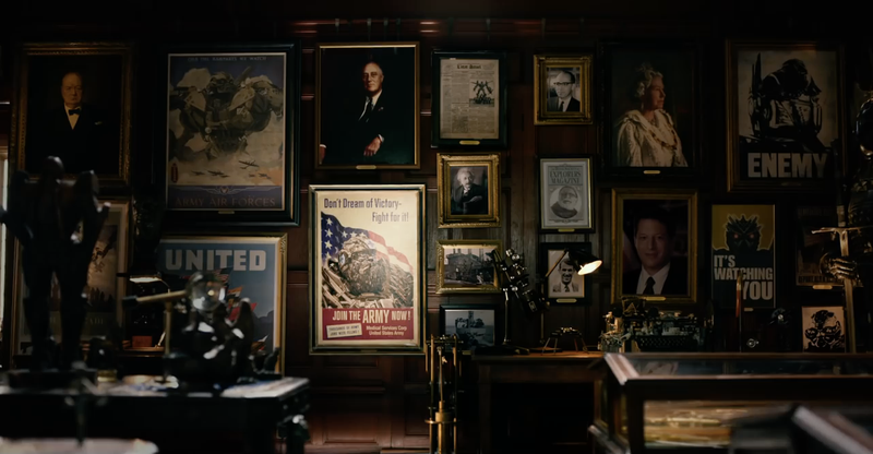 If the public at large didn’t know about Transformers, who are these posters for? On this wall: FDR, Winston Churchill, QEII, Al Gore, and Sam Witwicky’s grandfather. (Image: Transformers: The Last Knight, Paramount)